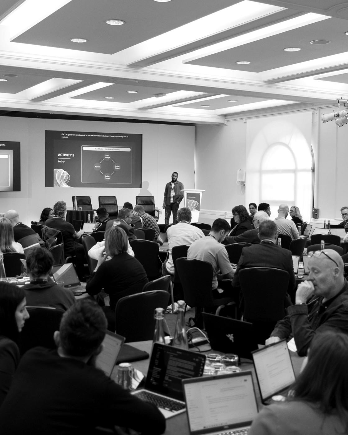 YUKEN delivering an AI session to a full audience at the Elevate London conference